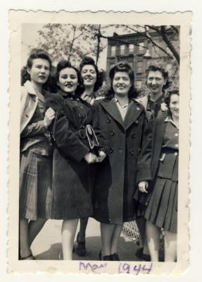 Six women by trees and building 