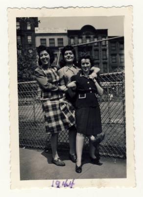 Three women by fence