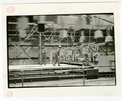 Two men operating machinery